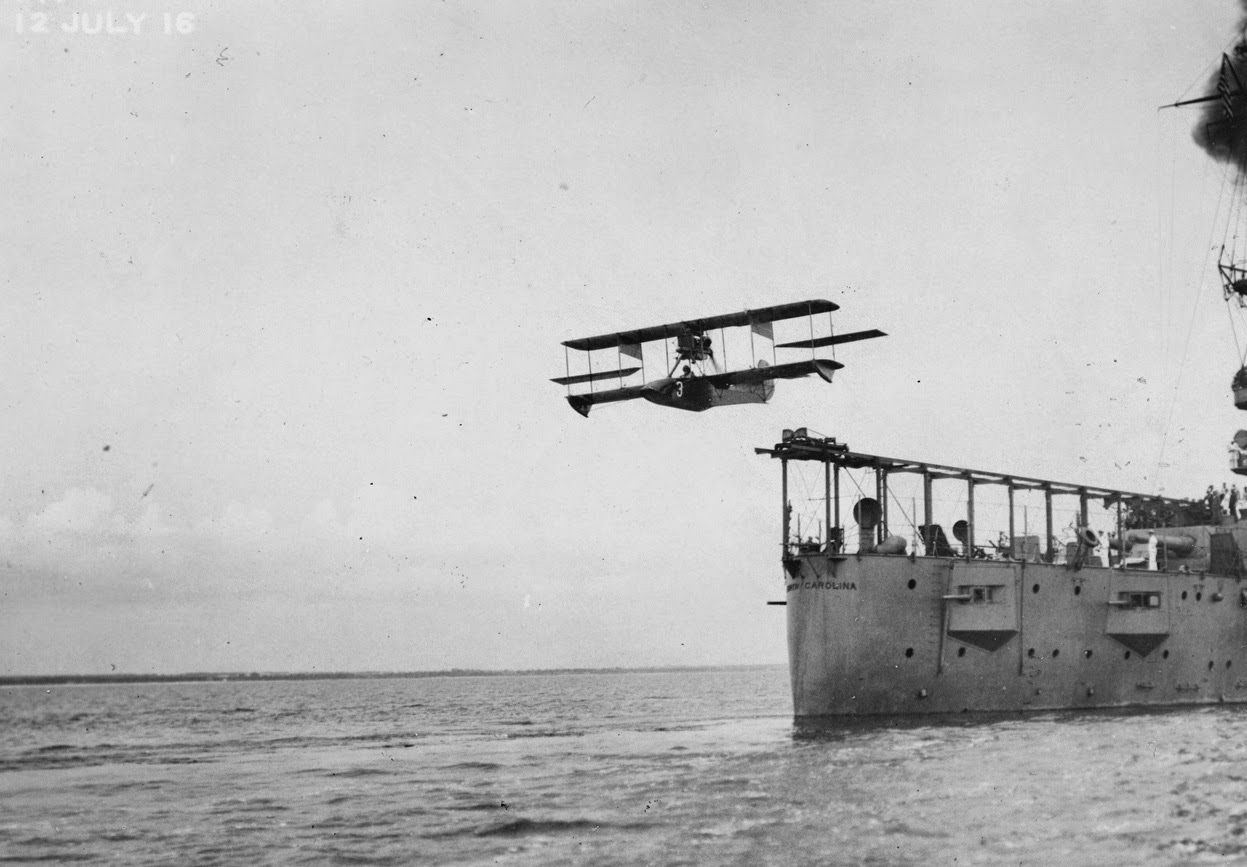 A Curtiss Model AB-2 airplane catapulted off the deck of the USS North Carolina, July 1916.