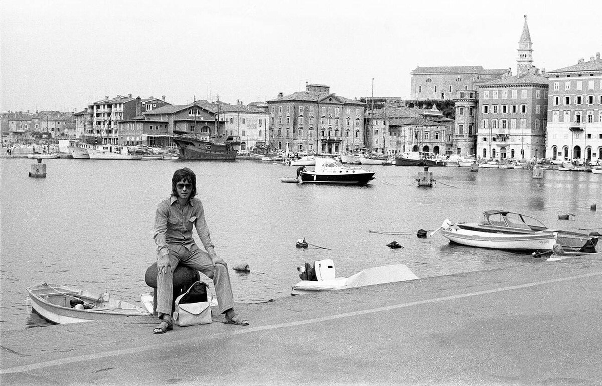 Male tourist in Piran Old Town Harbour, Slovenia, 1972.