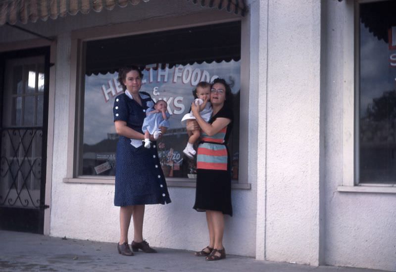 Women with babies standing in front of Health Foods store, Oklahoma