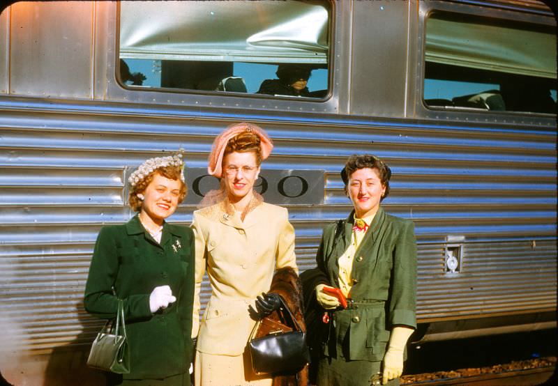 Women pose by the train
