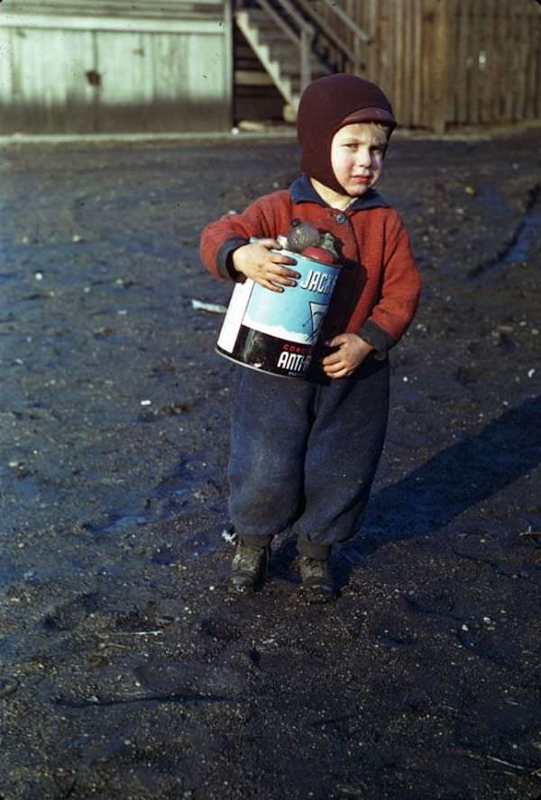 Moppet poses after getting pennies, Chicago, Illinois, 1941