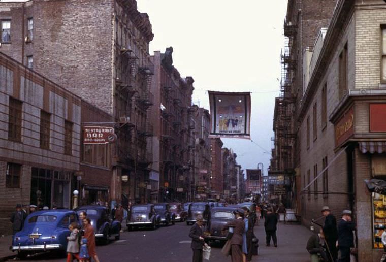 Two views looking up a street of many races, lower Manhattan, New York City, 1942
