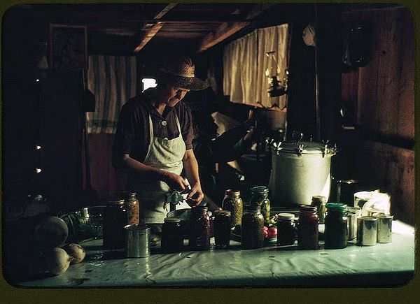 Wife of Jim Norris with canned goods, Pie Town, New Mexico, 1940