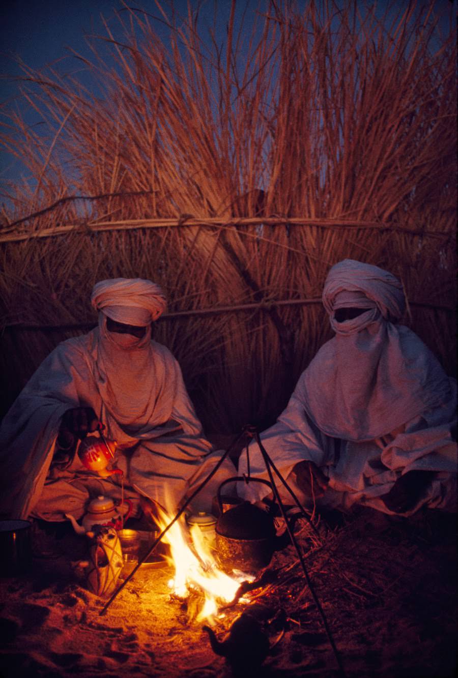 Tuareg goatherds drinking tea in their desert shelter at Hassi Izernene, Algeria, 1973