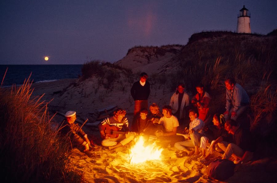 Friends gathered around a summer campfire at Great Point Lighthouse on Nantucket Island, Massachusetts, 1970