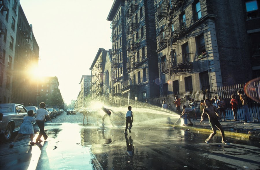 Youngsters refreshing themselves at a fire hydrant in Harlem, New York, 1977