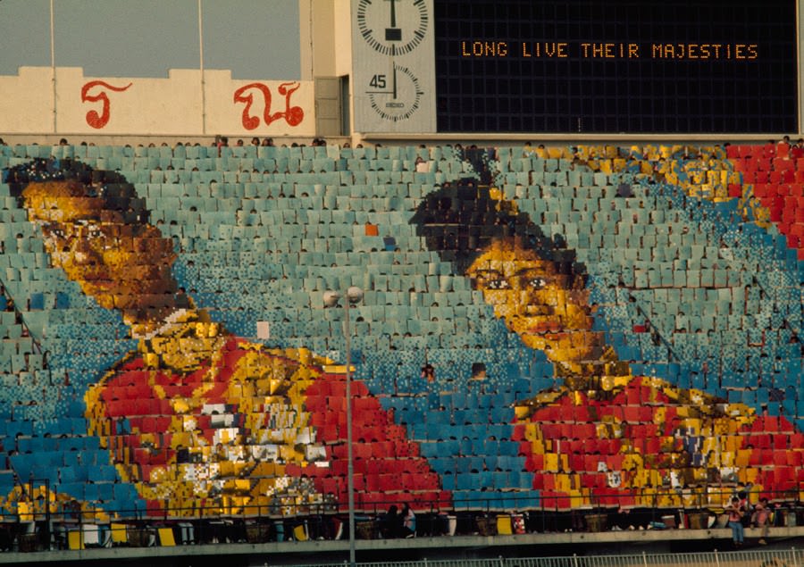 Flash card display of King Bhumibol and Queen Sirikit at a stadium in Bangkok, Thailand, 1973