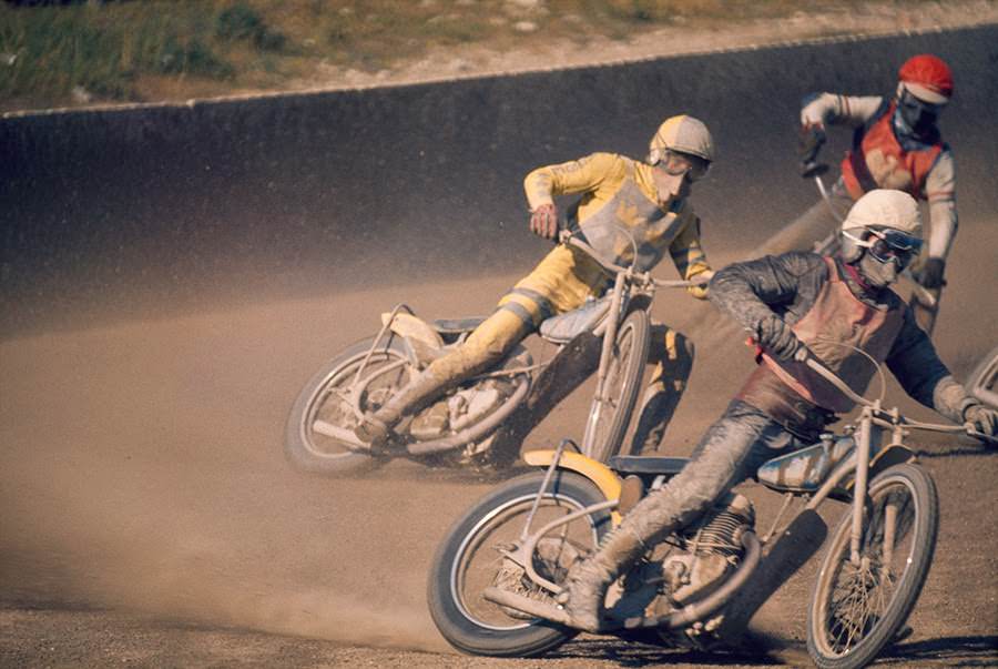 Motorcyclists careening into a turn during a race in Sweden, 1973