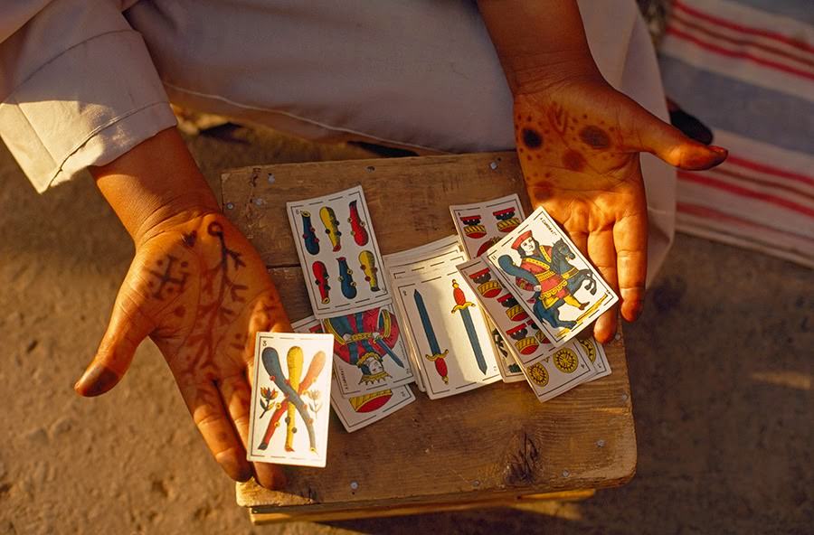 Fortune teller displaying cards in Jemaa el-Fnaa square in Marrakesh, Morocco, 1971