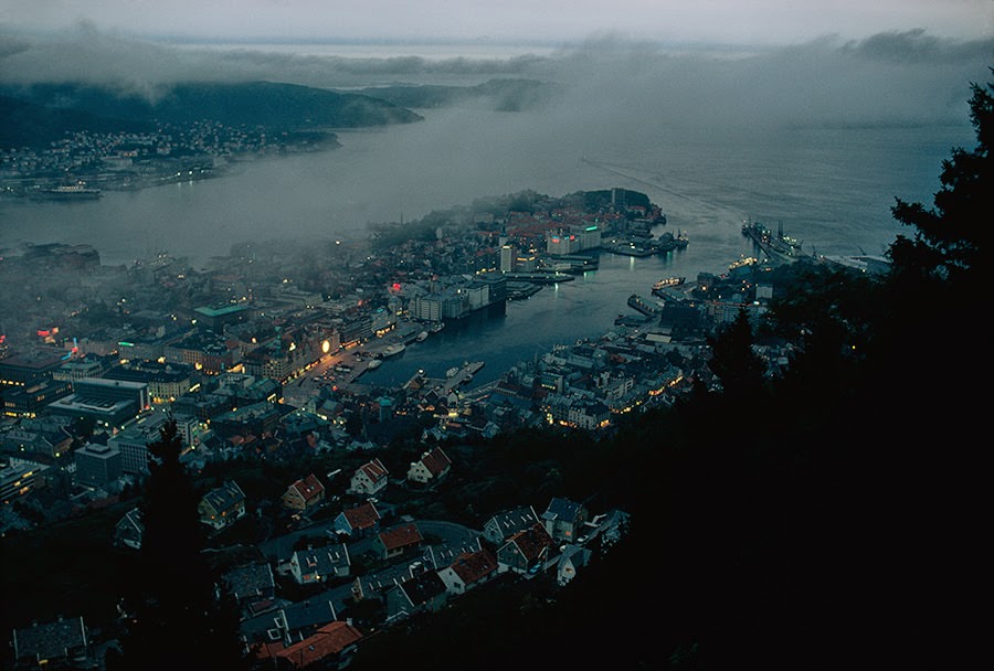 Dusk view of Bergen nestled against mountain walls and the fjord in Norway, 1971