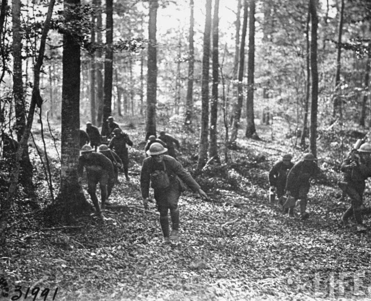 American machine gun platoon moving through a French forest towards the front lines during World War I.
