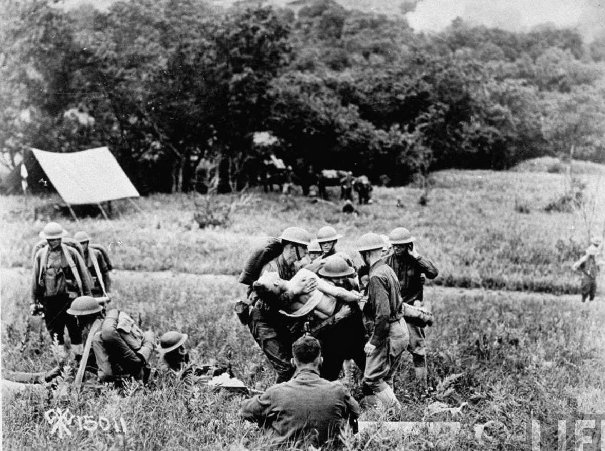 American medics carry wounded comrade on a litter during World War I.
