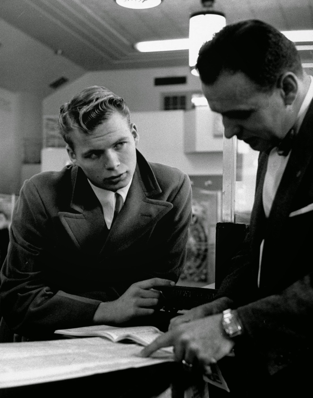 David Lenske talking with a banker about his AT&T shares, 1954