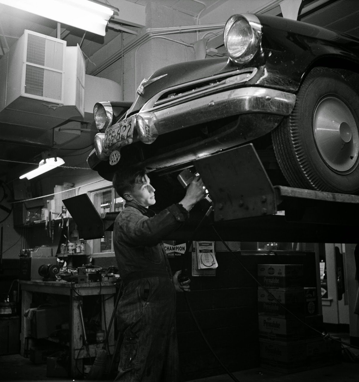 Teenage mechanic at work, 1954