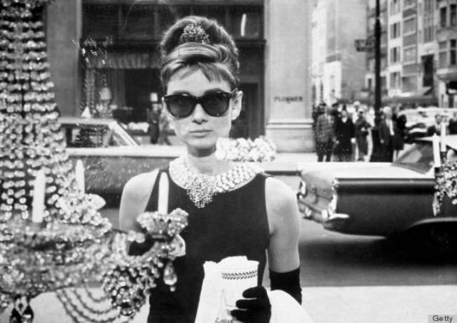 Sunglasses work with literally any outfit — even formal ones. In this infamous picture, Hepburn exuded “cool” by pairing Wayfarer-style shades with her jeweled-out LBD.