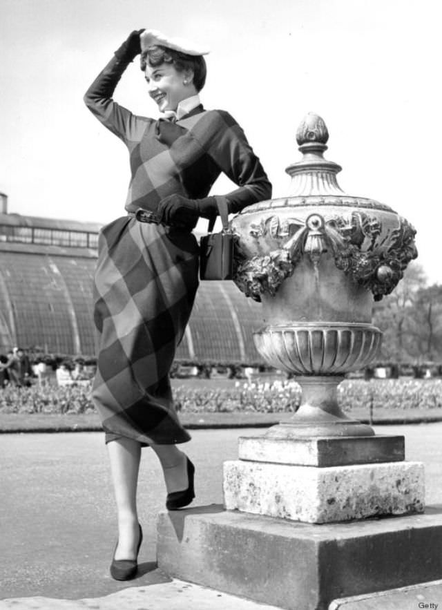 A belt cinched in the middle of a dress creates a lovely shape. Hepburn amped up her plaid dress with a tight belt and an awesome beret.