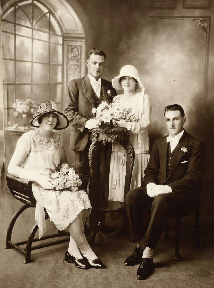 Bride and bridegroom with their bridesmaid and best man, 1925