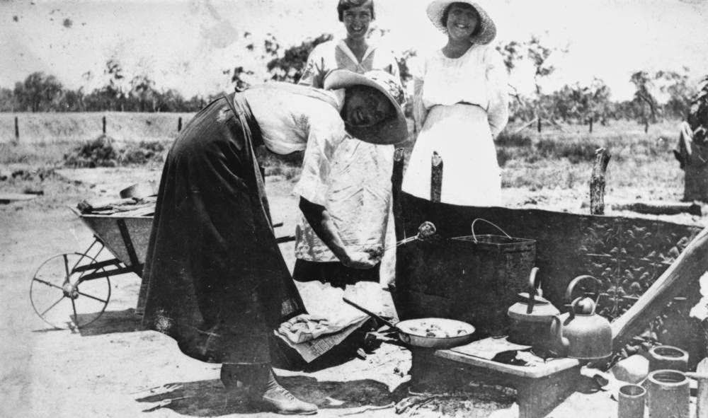 Cooking outside while a kitchen is added to a homestead.
