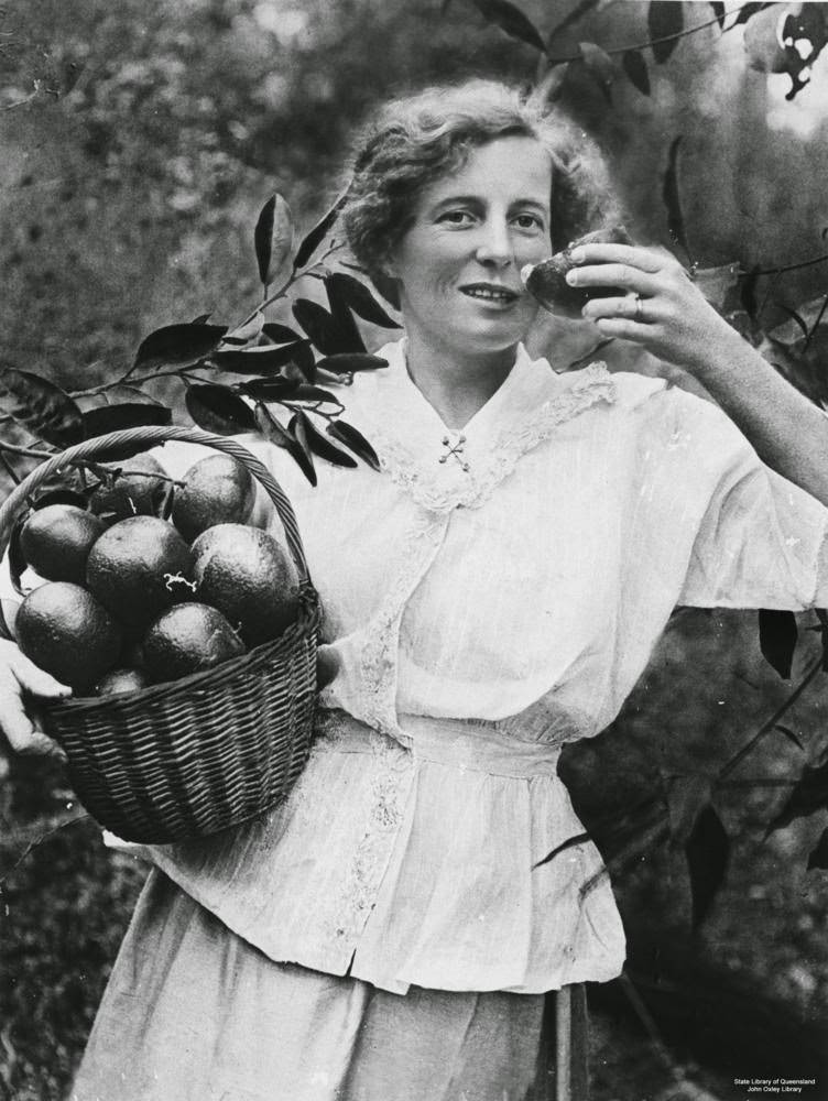 Woman with a basket of mandarins.