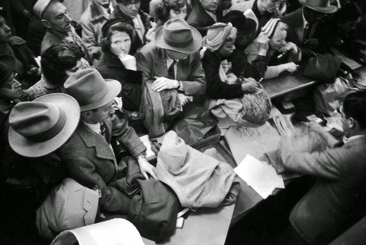 Shoppers around a cashier during a bargain rush sale at Hearn's department store in New York, 1954