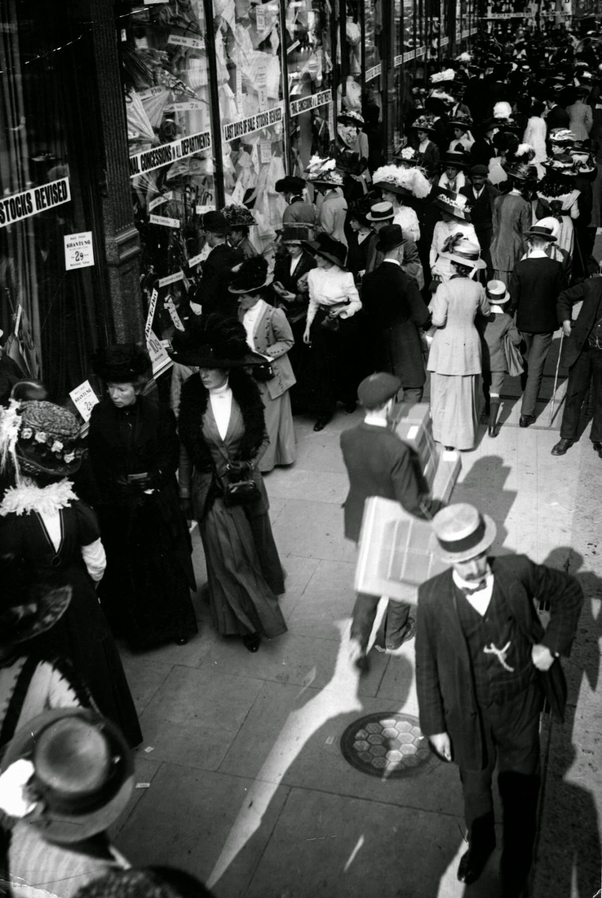 People shopping for bargains in a crowded street, 1910