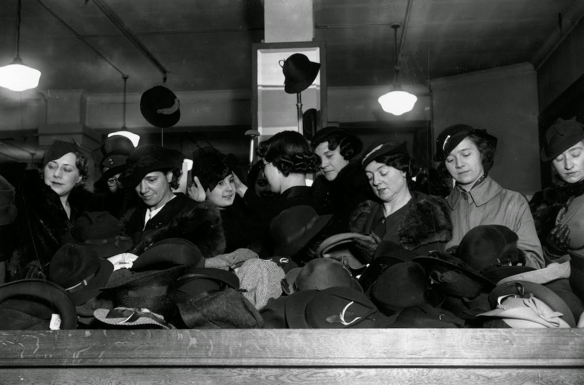 Bargain hunters shopping for hats during the January sales at Whiteley's department store in Bayswater, London, 1935