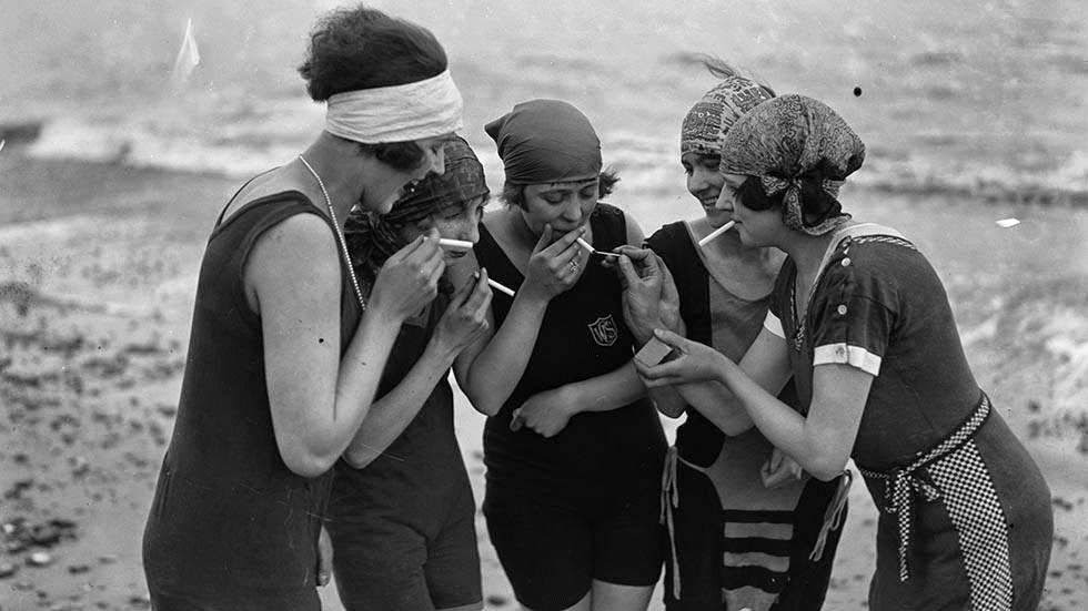 Bathing belles enjoying a smoke on the beach at Aldeburgh, Suffolk, 1929