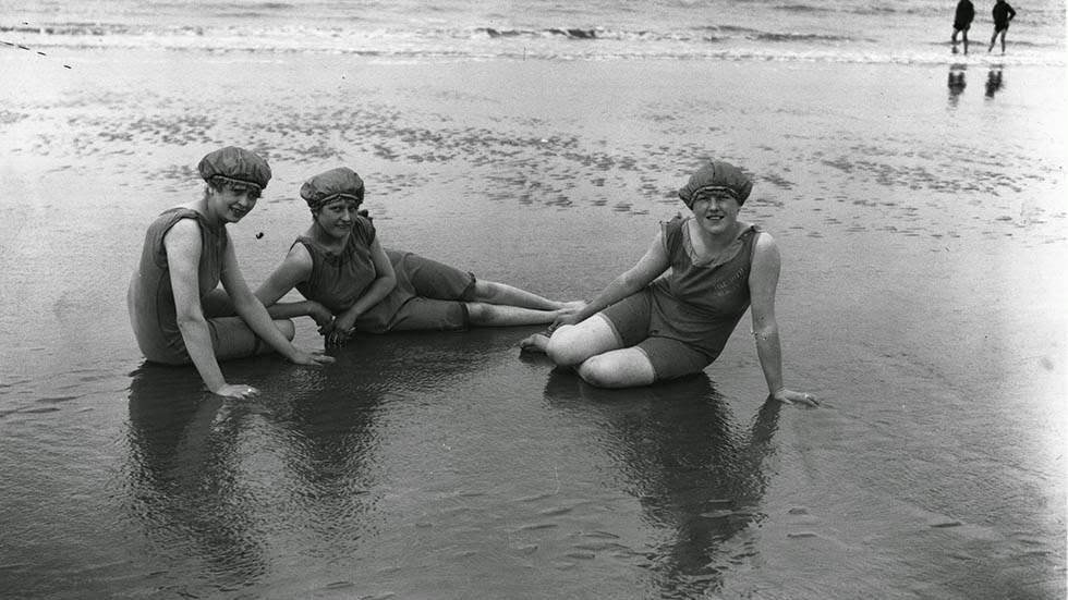 Three young girls bathing on Blackpool beach, 1920