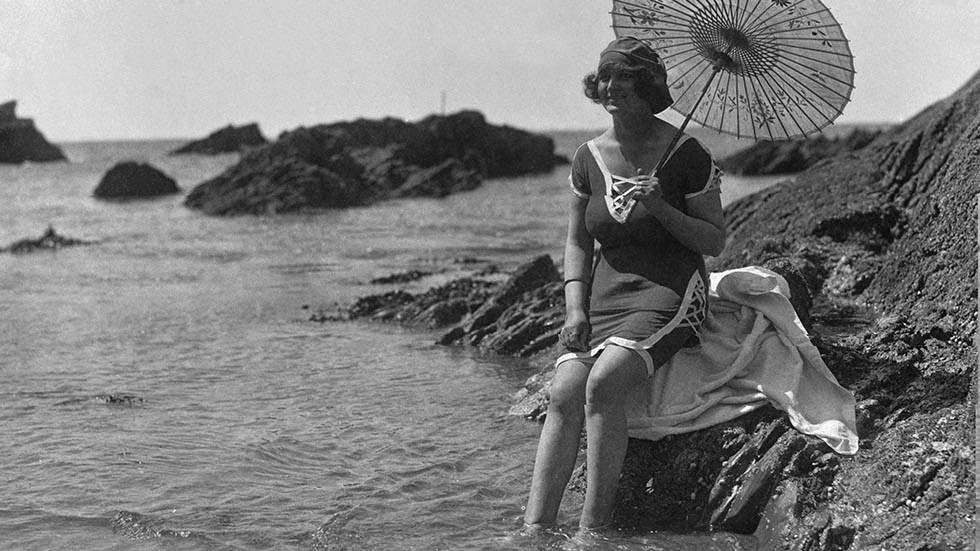 Bathing belle at Plymouth beach with her parasol, 1921