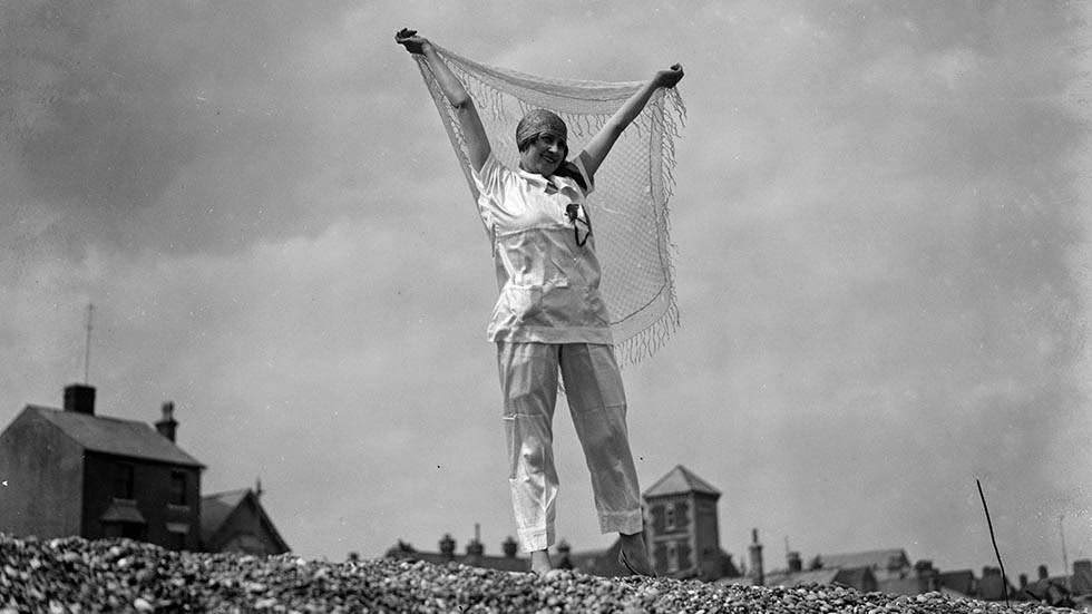 Woman wearing beach pajamas on an English beach, 1927