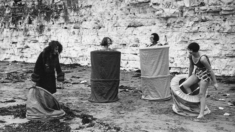 Bathers undressing using the skreenette on a public beach, 1929