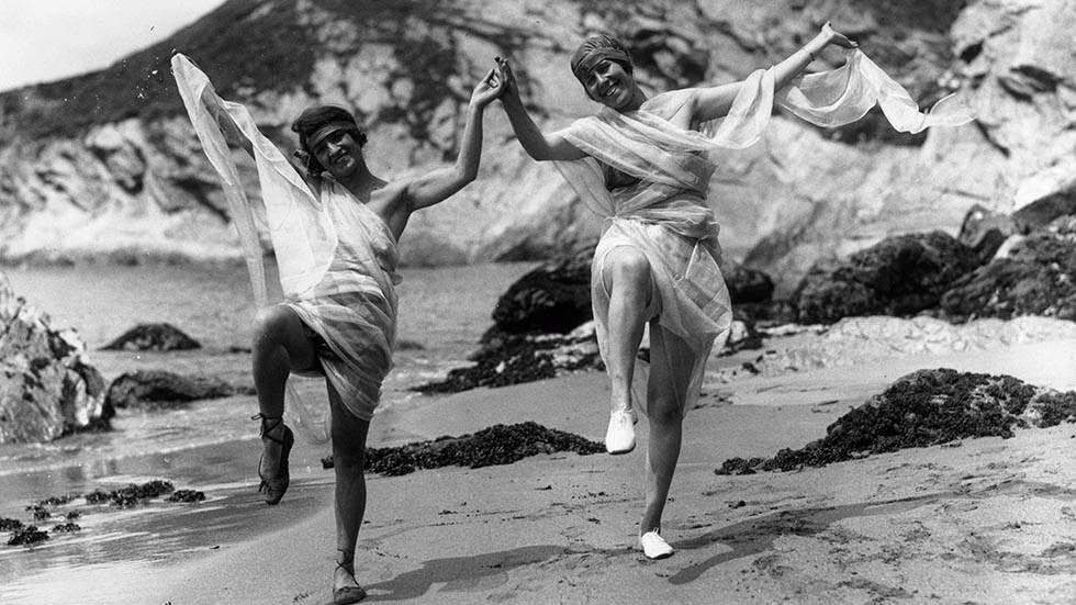 Bathers dancing hand in hand on the beach at Plymouth, Devon, 1921