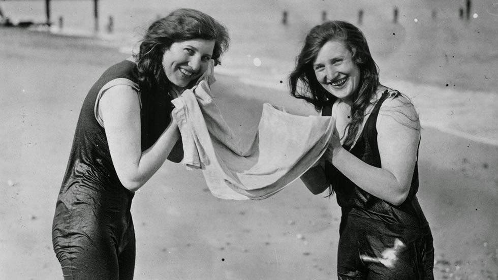 Vacationers sharing a towel on the beach at Lowestoft, 1926