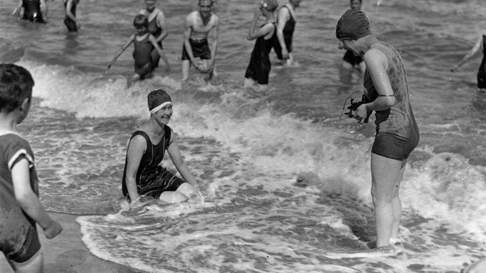 Woman taking a photograph of a fellow bather at the beach on the Isle of Thanet, 1927