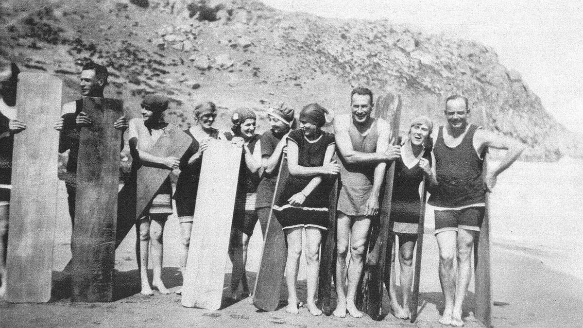 Samuel Burston and friends at Chiton Rocks Beach with early boogie board technology, 1920s