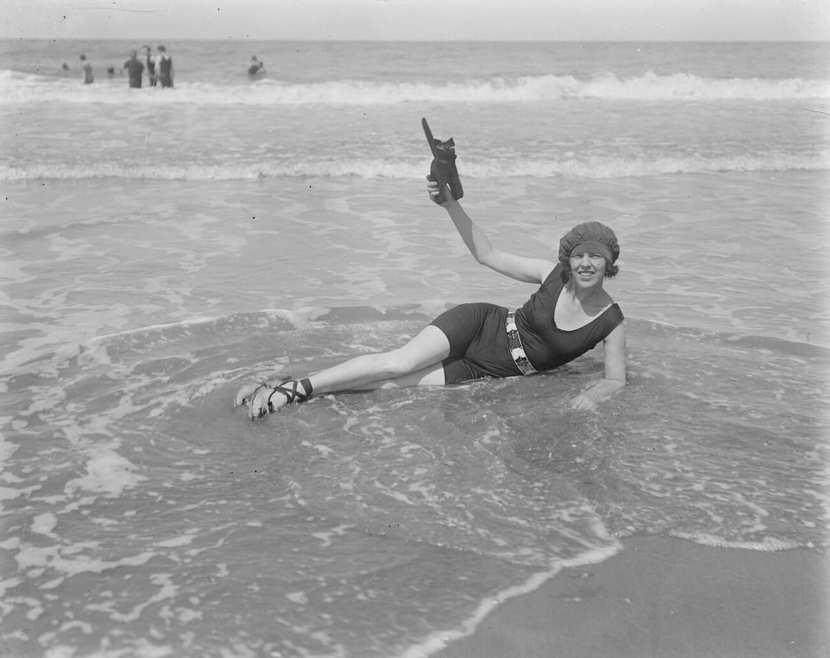 Mrs. Snowdon Hedley in the surf with her mascot at Deauville, 1921