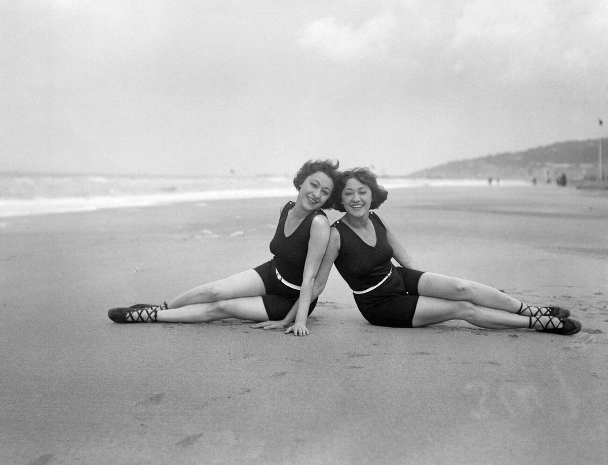 The Dolly Sisters posing on the sands of Deauville, France, 1922