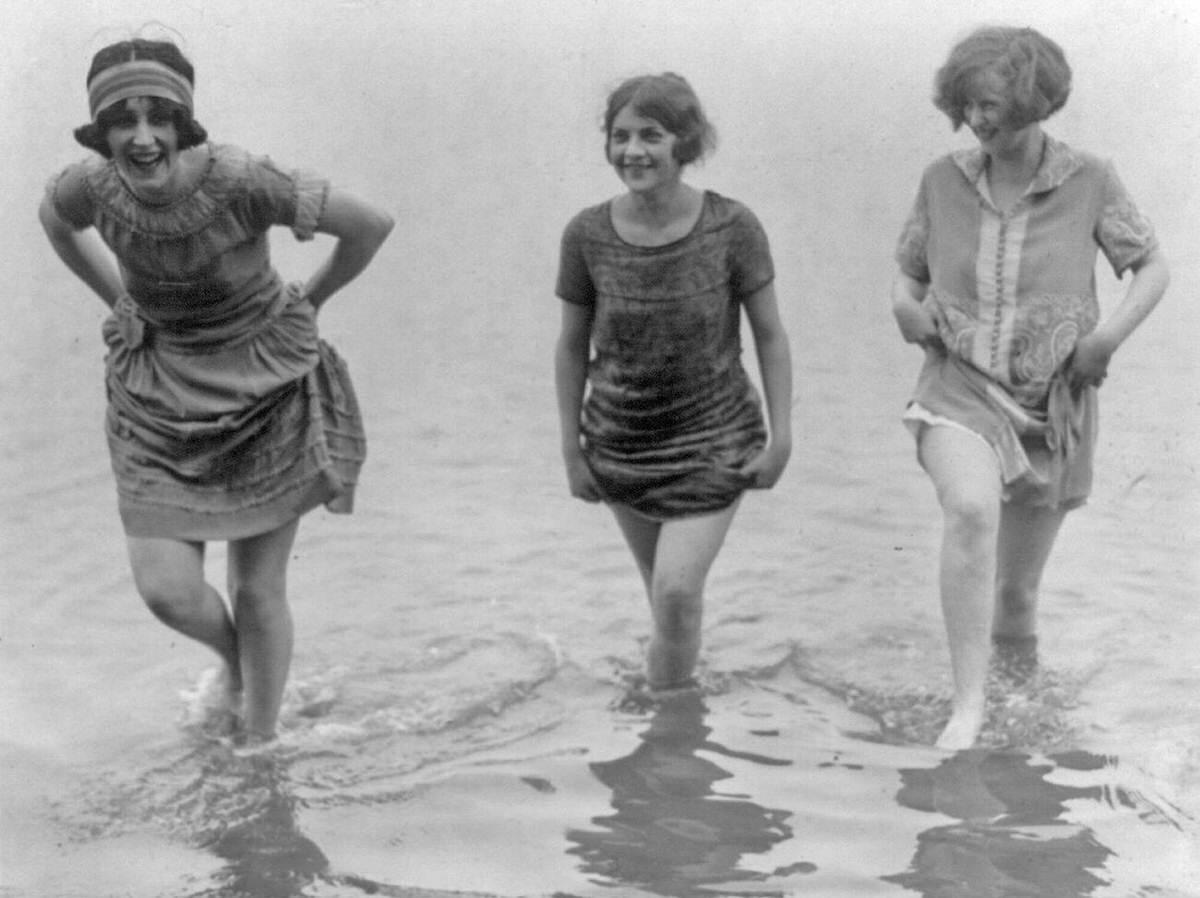 Models from a spring fashion show wading at Arlington Beach, 1924