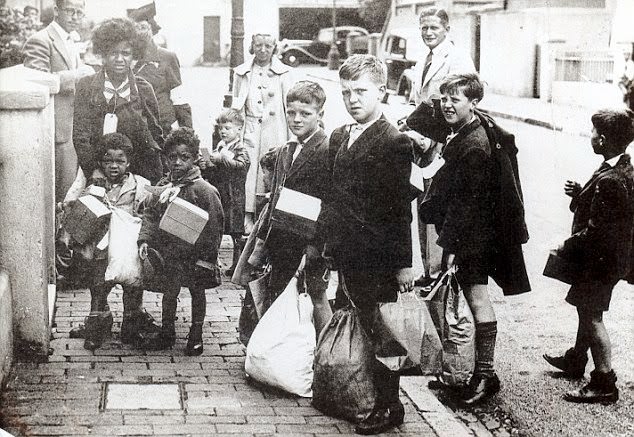 Approximately three million British children were evacuated from their city homes and sent to the countryside during World War II. The first of these mass evacuations took place in early September 1939 and saw children carrying boxes containing their gas masks. A paper label attached to each child identified who they were and their journey details. While in the country, the children continued their education in settings ranging from church halls to pubs – basically, wherever there was room.