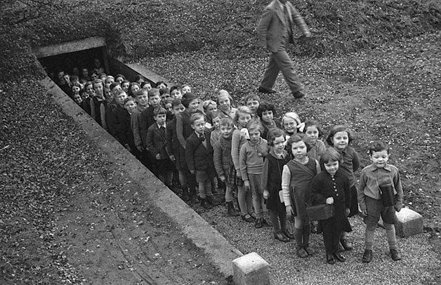 These children are pictured emerging from an air raid shelter on November 10, 1939, having successfully completed an air raid exercise. This particular shelter was built in a field next to the local school in the town of Gresford in northeast Wales.