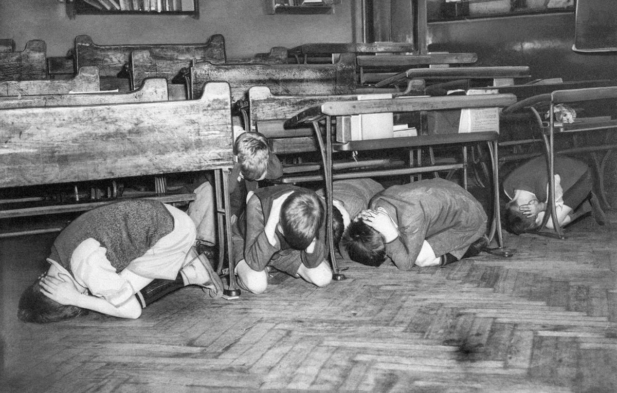 Because there was a long period at the beginning of the war during which no bombs were dropped, more than half the evacuees had already returned to their families by January 1940. However, this had never been part of the government’s plan, and as a result, many city schools remained closed, and the children themselves were left to drift through the streets during the day. The London Board of Education feared that students wouldn’t have enough time to get to an air raid shelter in the case of an attack and therefore instructed children to take shelter in the middle of the room. The children were to get away from windows, hide under their desks and cover the backs of their necks.