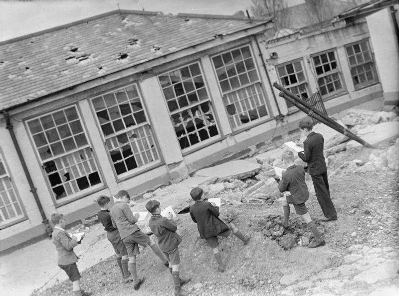 By late 1941, some degree of routine had been reestablished. These children from Moorside Road School in Grove Park, London can be seen sketching the damage caused to their school – including missing roof tiles, broken windowpanes and concrete reduced to rubble. The students carried their gas masks when they walked around the school. And the children still used the playground, despite the fact that it had been severely damaged by falling bombs.