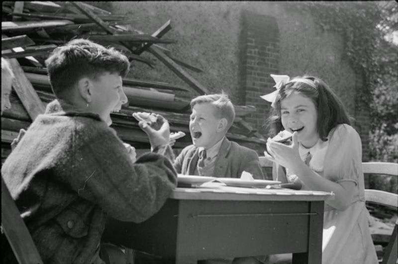 Even in the midst of war, there was still time for some simple pleasures – such as imported American cheese. These three school children can be seen enjoying a light snack in the playground of a ruined school in Farringdon in the London borough of Islington (in a picture likely taken in August or September 1941).