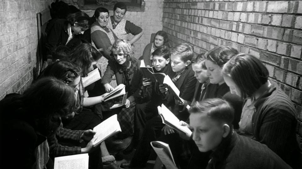 Schooling was disrupted not only by the evacuations and frequent moves, but also by the threat of bombs. Here, students and teachers from a school in Bermondsey in South London strive for a sense of normalcy. The photo, taken on March 29, 1941, shows students participating in a reading and discussion group.
