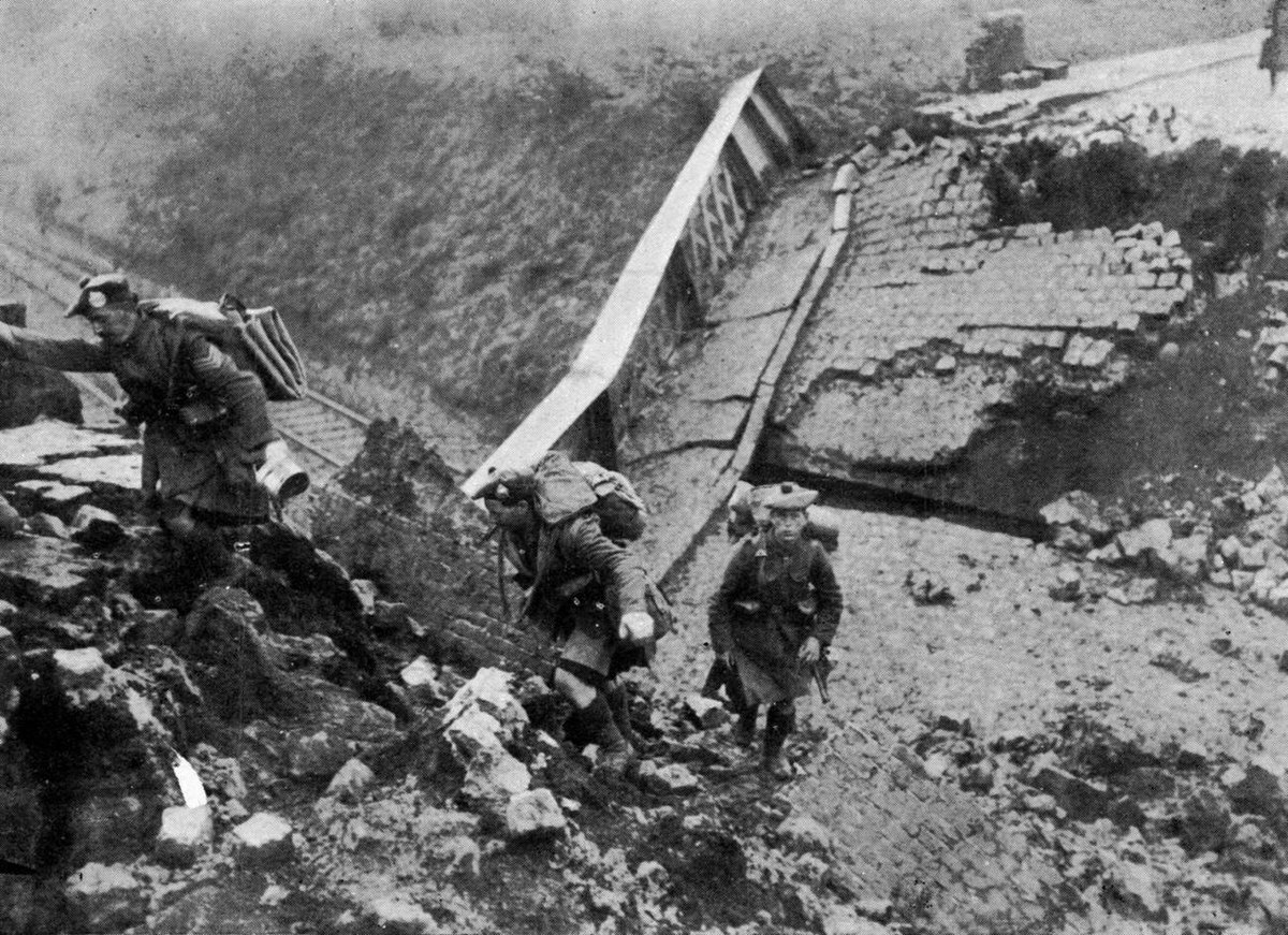 Highlanders crossing a railway bridge blown up by the Germans, 1918