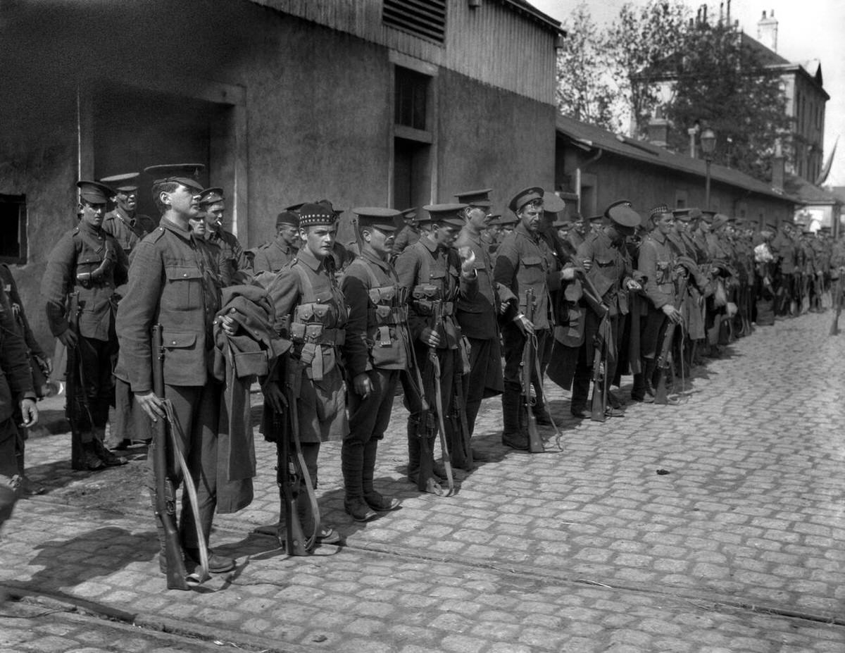 British soldiers of various regiments on a cobbled street in France, 1916