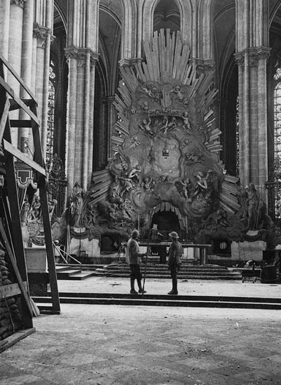 The wooden supports that were built to shield the altar at Amiens Cathedral from shell damage. In addition to these supporting planks, sandbags were also used to protect the interior furnishings and ornaments from bomb damage. Underneath the wooden support to the far left of the photograph, one can see some sandbags piled up on top of one another.