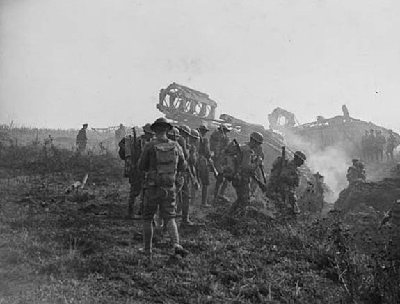Attack on Hindenburg line. Tanks and Troops advancing. With 'land battleships (tanks) in the background, this image shows infantry advancing during the attack on the famous Hindenburg Line. As the Hindenburg Line was finally overrun by the Allies in the autumn of 1918, it seems highly likely that this is when this photograph was taken.