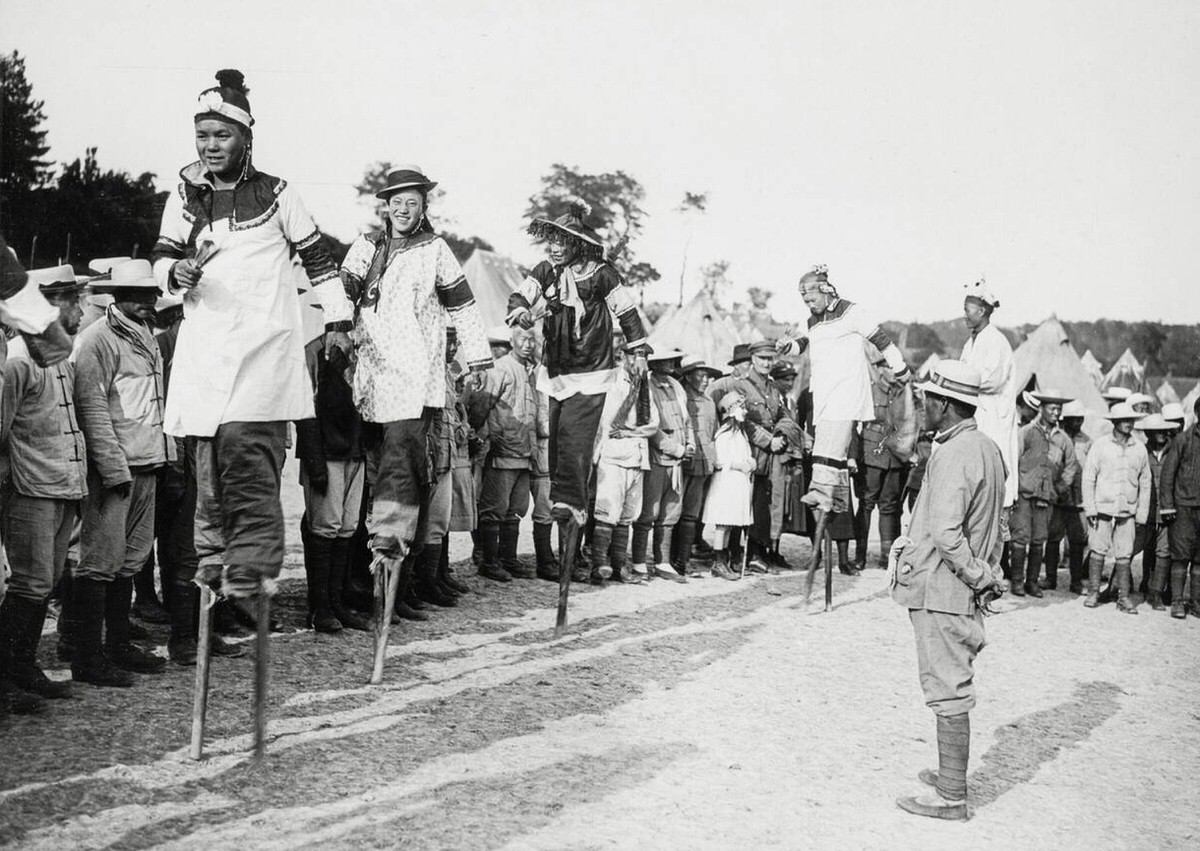 Chinese stilt walkers entertaining British troops in France, 1914