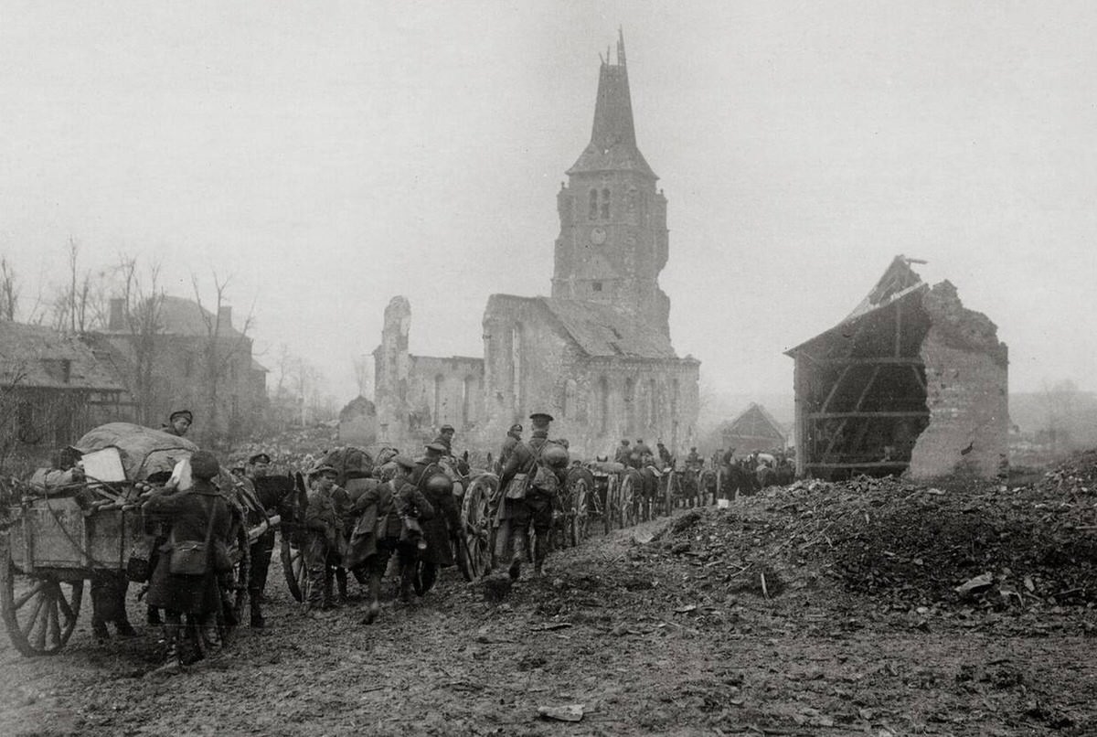 Troops moving through ruins behind the British line in France, 1914